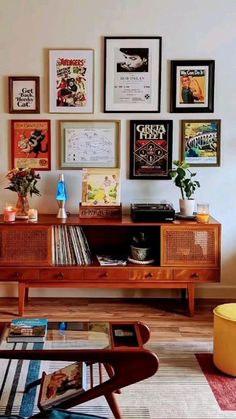 a living room filled with furniture and pictures on the wall above it's coffee table