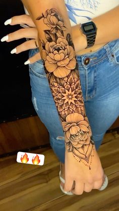 a woman's arm with flowers on it