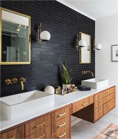 the bathroom is decorated in black and white with gold accents, including two double sinks