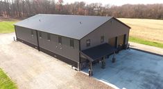 an aerial view of a large metal building in the middle of a rural area with lots of grass and trees