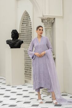 Introducing our stunning Lavender chiffon embroidered shirt hand-worked and embellished with minute mirror work details. Paired with matching raw-silk pants. This elegant dress is adorned with intricate details, featuring beautiful embroidery and embellishments. Elegant Purple Chanderi Palazzo Set, Elegant Purple Long Sleeve Palazzo Set, Elegant Long Sleeve Purple Palazzo Set, Elegant Purple Chinon Sets, Elegant Georgette Lawn Suit With Mirror Work, Chiffon Sets With Mirror Work For Eid, Elegant Purple Sets With Mirror Work, Traditional Chiffon Sets With Mirror Work, Designer Chiffon Sets With Mirror Work