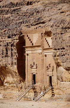 an ancient building built into the side of a mountain