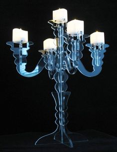 a glass candelabra with five lit candles