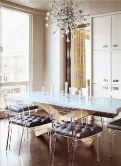 a dining room table with chairs and a chandelier