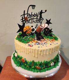 a birthday cake decorated with sports related items