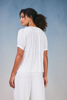 With its flowy shape and crinkle texture, this short-sleeve pleated top is just the right piece for creating effortlessly chic looks. It's softly textured and floats elegantly on the figure, drawn in by delicate ruffle trim. •Relaxed fit •Pullover styling •Cuffs Item number 2430190100% Polyester Summer Solid Blouse With Crinkle Texture, Chic Short Sleeve Blouse With Crinkle Texture, Billowy Short Sleeve Blouse For Summer, Summer Feminine Textured Tops, Textured Feminine Summer Tops, Feminine Textured Summer Tops, Flowy Short Sleeve Breezy Top, Elegant Summer Blouse With Crinkle Texture, Relaxed Fit Tops With Crinkle Texture And Short Sleeves