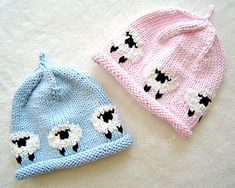 two knitted hats with black and white sheep on them