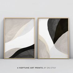 two framed art prints with black and white abstract shapes on the same wall, one is in