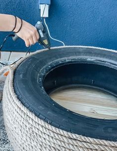 a person using a power drill to attach a tire