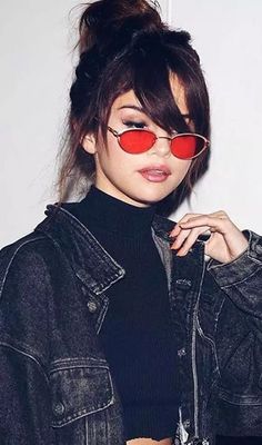 a woman with red sunglasses on her face