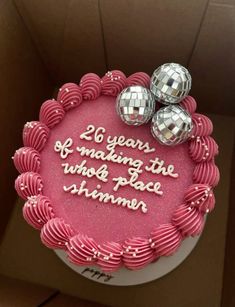 a birthday cake with pink frosting and disco balls on top that says, 20 years of making the who's place summer