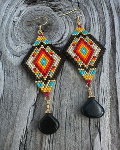 the beaded earrings are made with black beads and red, blue, yellow and green beads