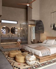 a large bed sitting in the middle of a bedroom next to two round mirrors on the wall