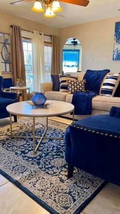 a living room filled with furniture and a ceiling fan