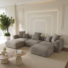 a living room with a large sectional couch and coffee table in the corner, along with a potted plant