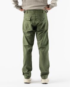 orSlow Slim Fatigue Pants Green. Military trouser made with a heavy duty cotton twill. Featuring two front and back pockets and a zip fly. 100% Cotton Branded patch Indigo dyed 9oz denim from Japan Custom orSlow brass buttons Custom Labels Wash cold, hang dry Made in Japan Teagan is 6'2 and wearing a size 2 orSlow orSlow, founded my Ichiro Nakatsu, has become globally renowned for pairing rugged construction with refied details. Inspired by Americana, denim is the brands hallmark. Known for reco Utility Cotton Jeans With Welt Pockets, Khaki Cargo Pants With Pockets In Chino Cotton Twill, Tapered Utility Cotton Pants, Khaki Chino Cotton Twill Work Pants With Pockets, Khaki Cotton Jeans With Welt Pockets, Military Style Straight Leg Cotton Bottoms, Tapered Cotton Utility Pants, Military Style Work Pants With Patch Pockets, Utility-style Cotton Tapered Pants