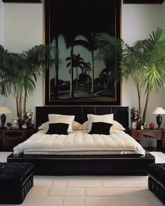 a bedroom with palm trees in the background