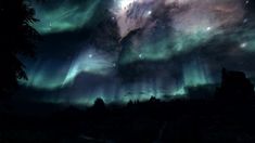 the sky is filled with bright green and purple aurora bores, as well as stars