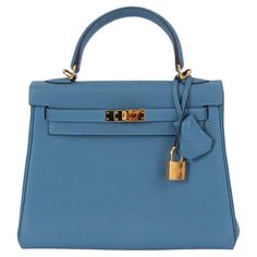 100% authentic Hermès Kelly II 25 Retourne bag in Azur blue Veau Togo leather with gold-plated hardware. Lined in Chevre (goat skin) with an open pocket against the front and a zipper pocket against the back. Has been carried and is in virtually new condition. Comes with fullset. Measurements Height 19cm (7.4in) Width 25cm (9.8in) Depth 9cm (3.5in) Drop of the Handle 9cm (3.5in) Hardware Gold-Plated Blindstamp C (2018) All our listings include only the listed item unless otherwise specified in t Timeless Blue Bag With Top Handle, Blue Formal Bags With Gold-tone Hardware, Formal Blue Bags With Gold-tone Hardware, Timeless Blue Rectangular Bag, Timeless Blue Rectangular Bags, Timeless Blue Business Bag, Timeless Blue Business Bags, Blue Business Satchel With Gold-tone Hardware, High-end Blue Evening Satchel