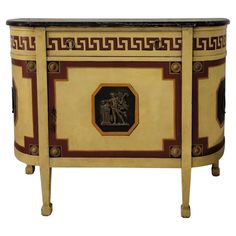 an ornately decorated sideboard with two figures on it's front and sides