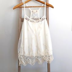 Brand New With Tags, Ivory Camisole With Beaded Lace Overlay, Size Xs Features Racer Back Style, Lace Overlay With Gorgeous Beaded And Sequin Detail Made Of 52% Cotton, 48% Nylon (Outer Layer) 100% Polyester (Cami) Measures Approximately 15" From Armpit To Armpit 26" From Shoulder To Hem White Camisole Halter Top For Summer, Spring Embellished Sleeveless Halter Top, Spring Sleeveless Tank Top With Delicate Straps, Embellished Sleeveless Halter Top For Summer, Embellished Halter Neck Top For Spring, Sleeveless Lace Top With Delicate Straps, White Camisole Halter Top For Spring, Chic Lace Trim Halter Top For Spring, Elegant White Cami Vest