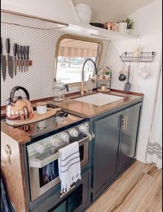 a kitchen with an oven, sink and counter top in the middle of it's room