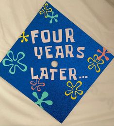 a blue graduation cap with four years later written on it