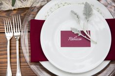 a place setting with red napkins and silverware