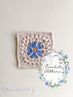 a crocheted square with blue flowers on it and the words, crochet pattern