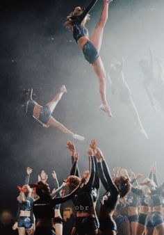 the cheerleaders are jumping in the air