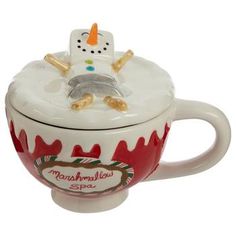 a ceramic cup with a snowman design on the lid and handle, sitting in front of a white background