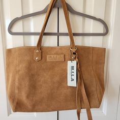 M.I.L.A Leather Tote Bag Tassel Front Magnetic Snap Closure Camel Color Never Used 18 In Across 5 In Depth 10 In High Brown Medium Shoulder Bag For Everyday, Medium Brown Shoulder Bag For Everyday, Everyday Medium Brown Shoulder Bag, Chic Medium Brown Shoulder Bag, Everyday Camel Hobo Bag With Adjustable Strap, Cognac Suede Bag For Daily Use, Medium Brown Bag For Everyday Use, Camel Hobo Bag With Leather Handles, Everyday Camel Double Handle Hobo Bag