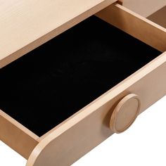 an open drawer with black paper in the bottom and wooden handles on it's sides