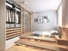 a bedroom with wooden steps leading up to the bed and closets on both sides