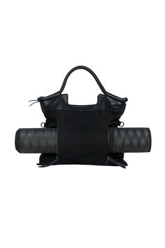 a black handbag sitting on top of a white surface with two straps around it