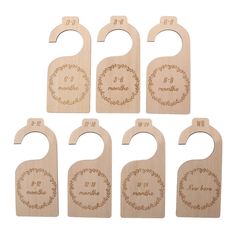 six wooden wine bottle openers with engraved names and numbers on the front, set of 6