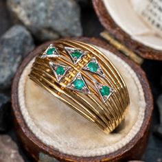 This gorgeous retro vintage emerald ring features open yellow gold wire work with six round cut emeralds set into white gold milgrained plaques at the top. The ring is crafted in 18k gold and has a rich natural patina. Vintage Emerald Ring, Emerald Ring Vintage, Crown Jewels, Gold Wire, Recycled Gold, Wire Work, Emerald Ring, Estate Jewelry, Turquoise Ring