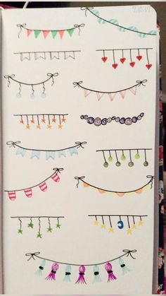 an open notebook with many different colored pins and ribbons hanging from it's sides