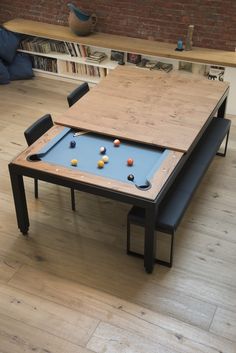 a table with a pool on it in front of a book shelf and bookshelf