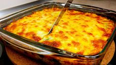 a person cutting into a casserole dish with a knife