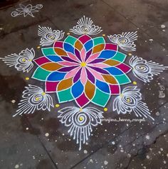 a colorful flower design painted on the ground