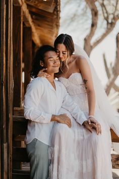 a bride and groom hugging each other on their wedding day