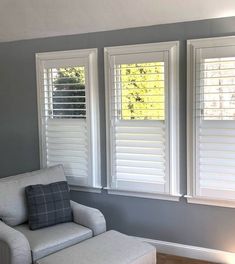 three windows with white shutters in a living room