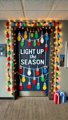 an office door decorated with christmas lights and holiday decorations that say light up the season