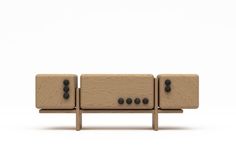 a wooden bench with two speakers on it's back end and three black knobs