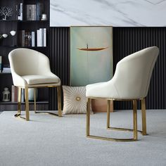 two white chairs sitting next to each other in a living room