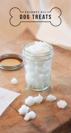 a wooden cutting board topped with a jar filled with sugar and small pieces of cotton