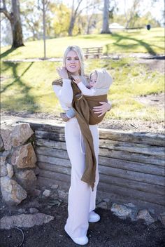 a woman holding a baby in her arms