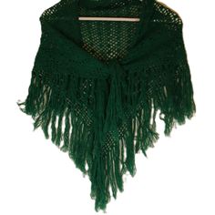 a green shawl with fringes on it