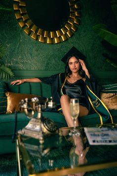 a woman sitting on top of a green couch